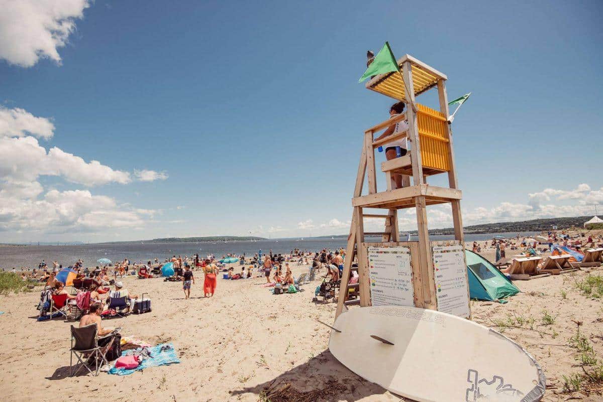 Baie de Beauport beach in Quebec City with swimmers and a lifeguard tower