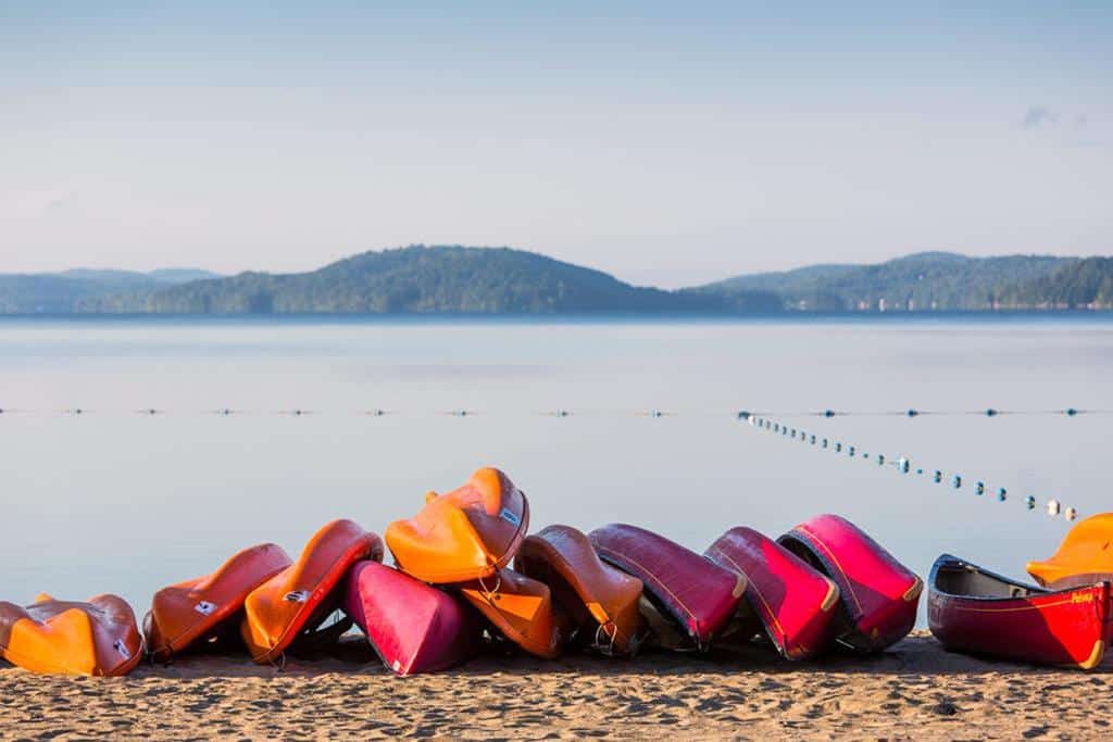 Colourful canoes on Lac-Simon Beach in the Outaouais region of Quebec