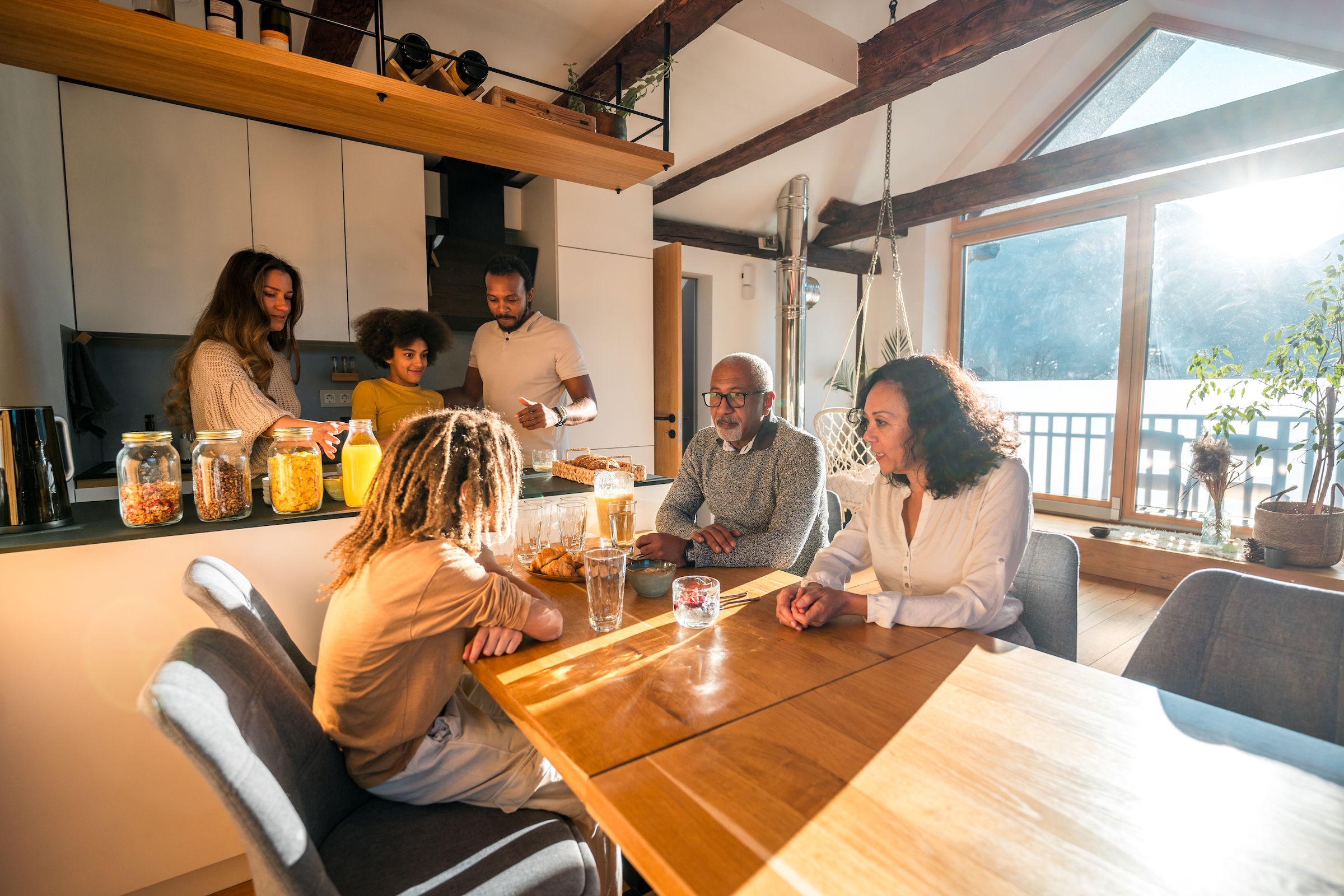 Family gathered around the table in a bright cottage kitchen in Quebec.