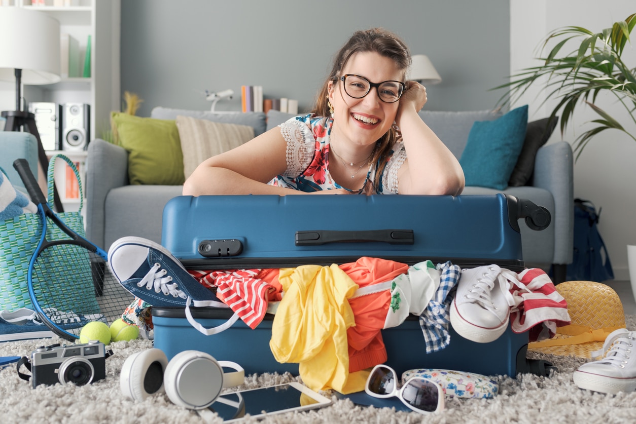 Traveller packing clothes and essentials for a cottage getaway in Ontario